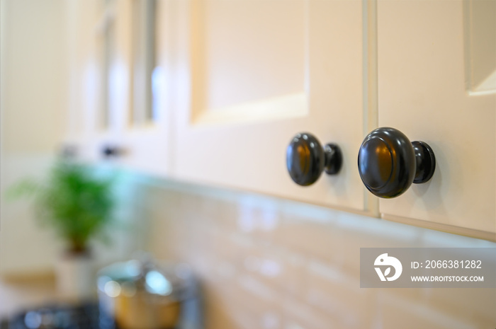 closeup to knobs at kitchen cabinet doors