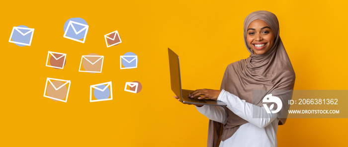 Happy Black Muslim Woman With Laptop And Flying Envelopes On Background