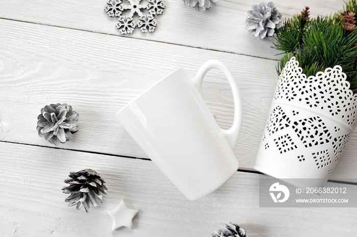 Mockup white cup on a wooden background, in Christmas decorations. The top view is photographed