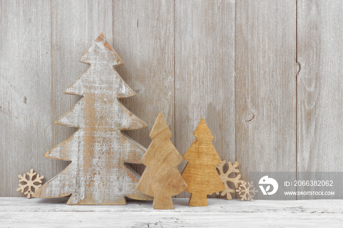 Rustic wooden Christmas trees against a light gray wood background