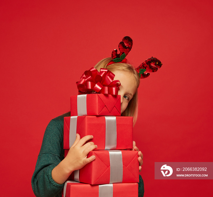 Smiling funny child (kid, girl) in Reindeer Hairband