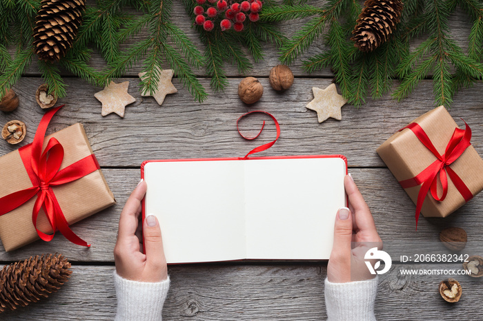 Girl reading blank book during christmas holidays