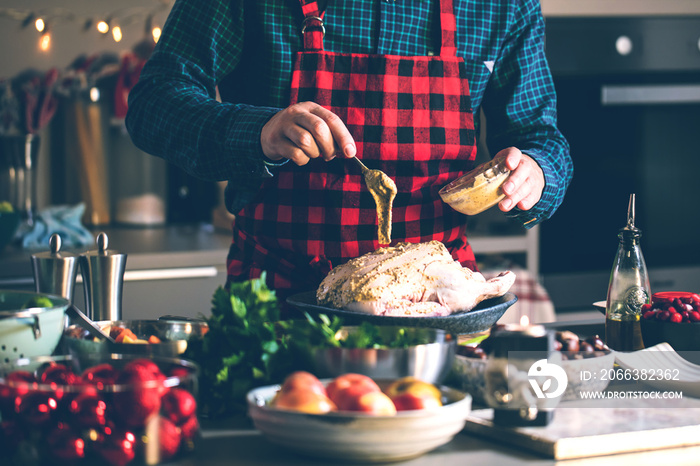 Man preparing delicious and healthy food in the home kitchen for christmas (Christmas Duck or Goose)