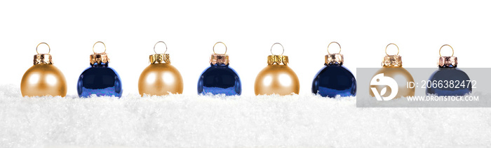 Christmas border of blue and gold ornaments in snow isolated on a white background