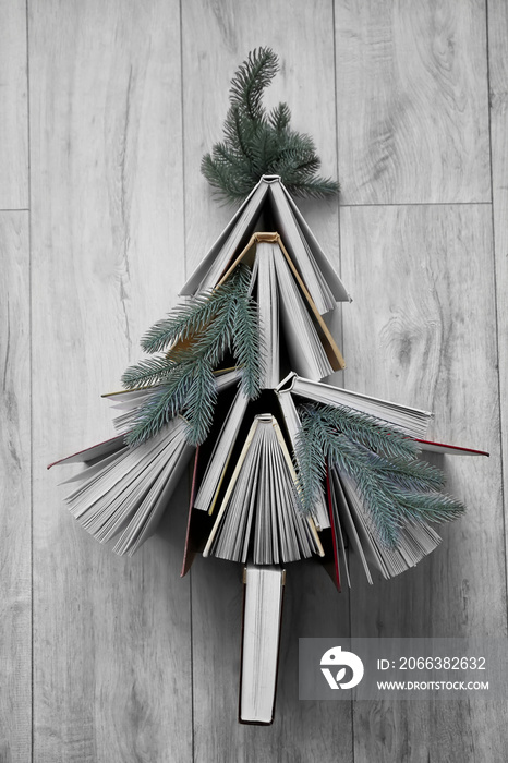Christmas composition with books on light wooden background