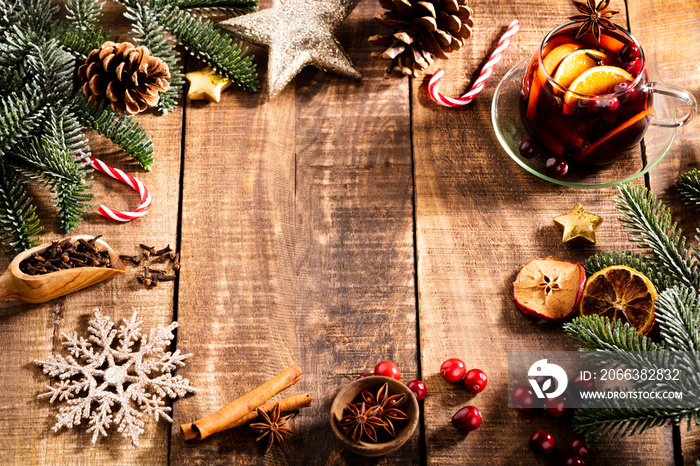 Christmas mulled wine with spices on a wooden rustic table.