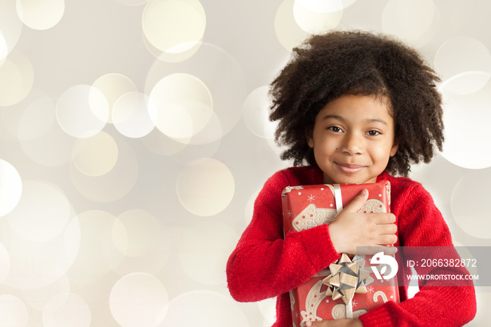 Christmas concept. Happy adorable african american child girl with christmas gift in hands isolated 