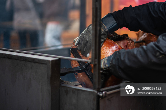 Big juicy pork leg on the grill. Prague Christmas fair. Traditional Czech food. National cuisine. Th