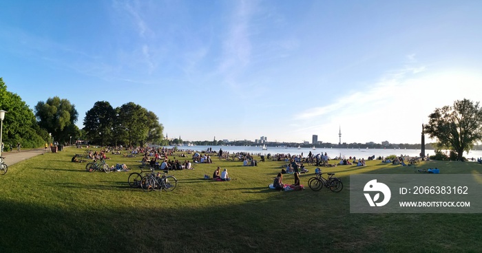 People sitting and having a barbecue at Alster Lake, Hamburg, Germany