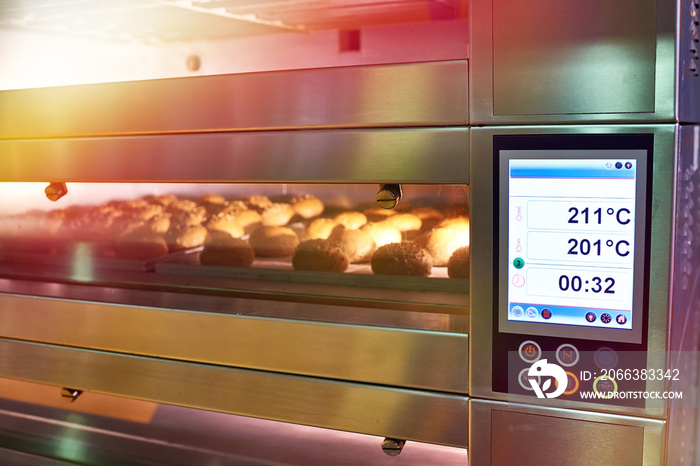 LCD screen of oven with bread in bakery