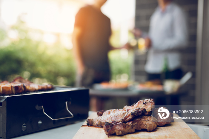 Close up grill with meat and sausage ready for socializing celebrate with friends at outsite home.