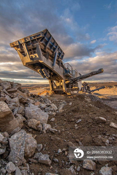 Heavy and mobile machinery in a quarry to transform stone into construction material