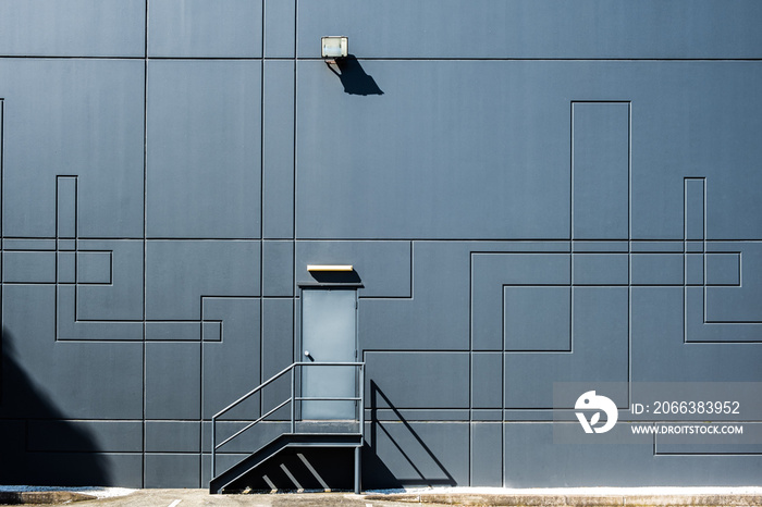 Clean geometric shapes of industrial architecture - back door entrance into warehouse building