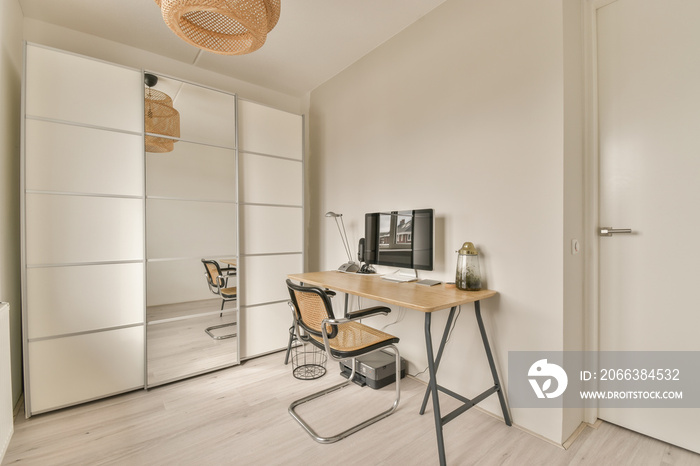 Comfortable chair placed near desk with computer monitors and whiteboard in light workplace in moder