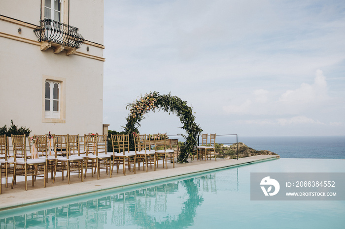 Wedding decorations. The ceremony area in the villa by the pool overlooking the sea is decorated wit