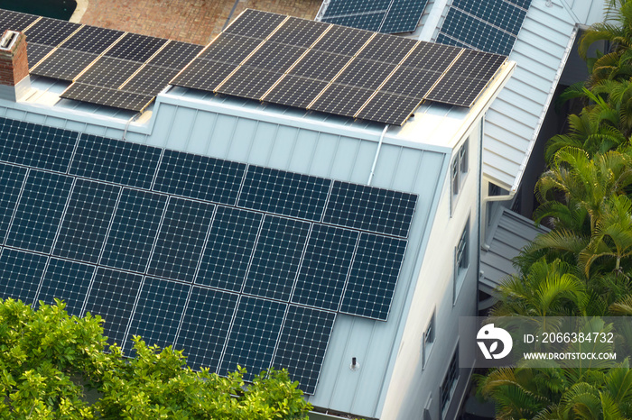 New american residential house with rooftop covered with solar photovoltaic panels for producing of 