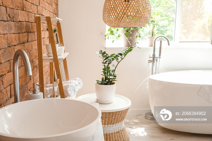 Stylish interior of modern bathroom with clean towels