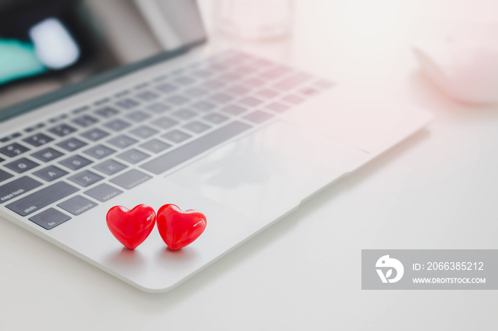 Valentines Day theme,Couple red hearts on laptop on white table in office.Concept of Online dating.