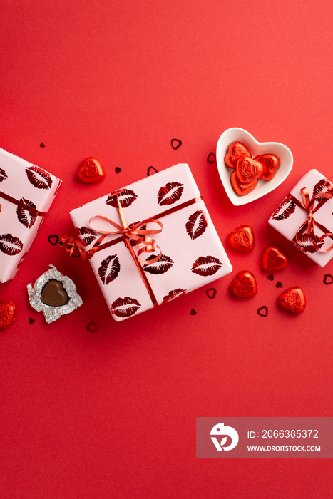 Valentines Day concept. Top view vertical photo of present boxes in wrapping paper with kiss lips p