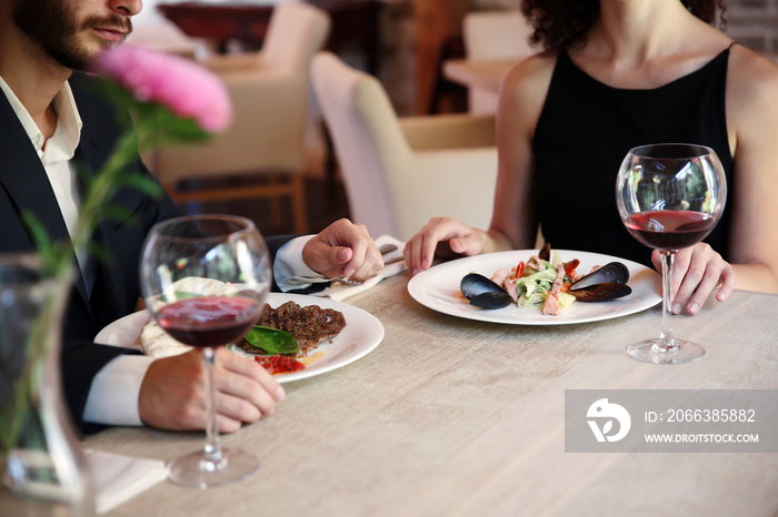 Man and woman having dinner at restaurant, closeup