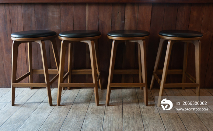 Row of wooden chairs or stools vintage in front of counter bar interior retro style decoration