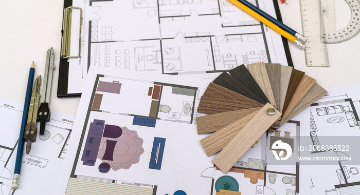 wooden vinyl samples with drawing instruments onn house plan blueprint