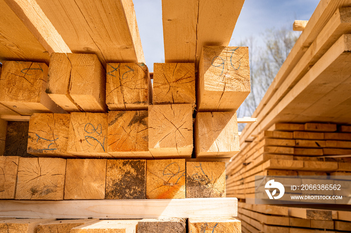 Stack of construction wood planks prepared for build a house