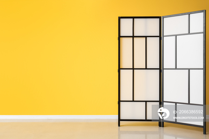 Folding screen near yellow wall