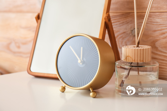 Alarm clock on chest of drawers in interior of room