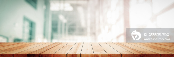 Panoramic empty clean wood counter table top on blur glass window white light background for product