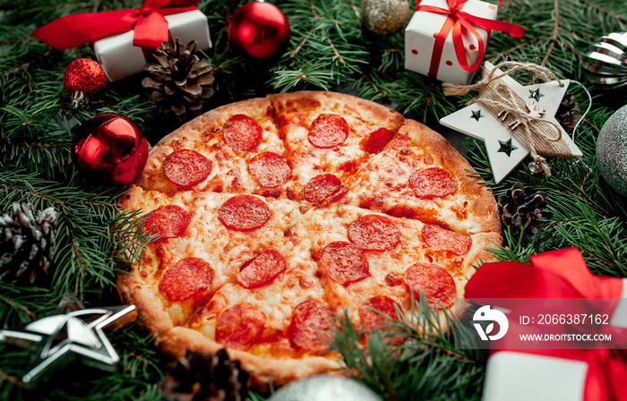 Christmas pepperoni pizza with Christmas decorations, gift, spruce, toys