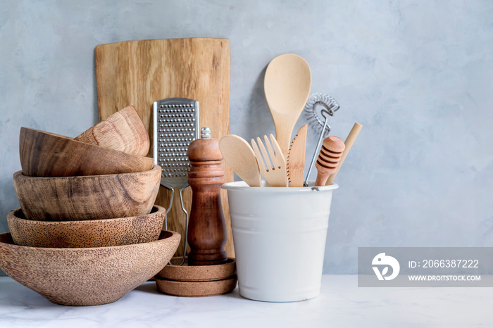 Stylish kitchen background with kitchen utensils on marble countertop, empty space for text, front v