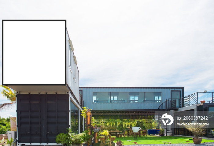 Modern metal building made from shipping house containers and blue sky background .empty white billb