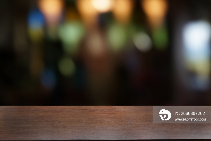 Empty dark wooden table in front of abstract blurred bokeh background of restaurant . can be used fo