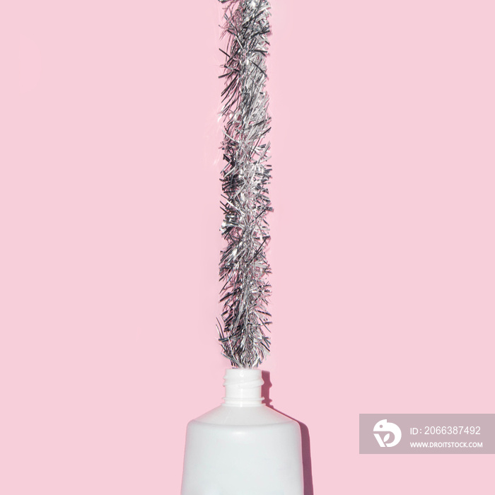 Creative Christmas party idea. Xmas tree decoration on pastel light pink background. Minimalistic Ne