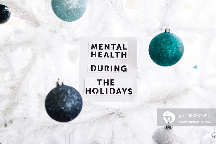 mental health during the holidays text on festive Christmas tree, managing overwhelm and expectation