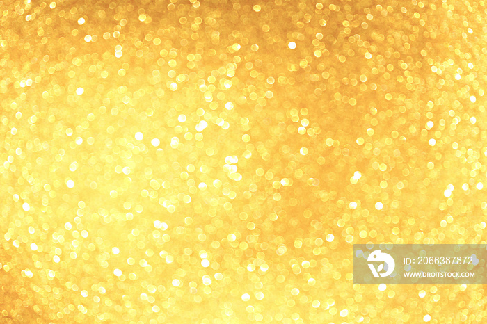 Golden sparkle glitters with bokeh effect and selectieve focus. Festive background with bright gold 