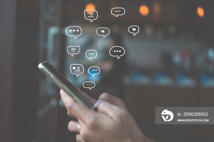 Women hand using smartphone typing, chatting conversation in chat box icons pop up. Social media mak