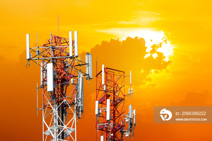 Telecommunication antennas tower in sunset background.