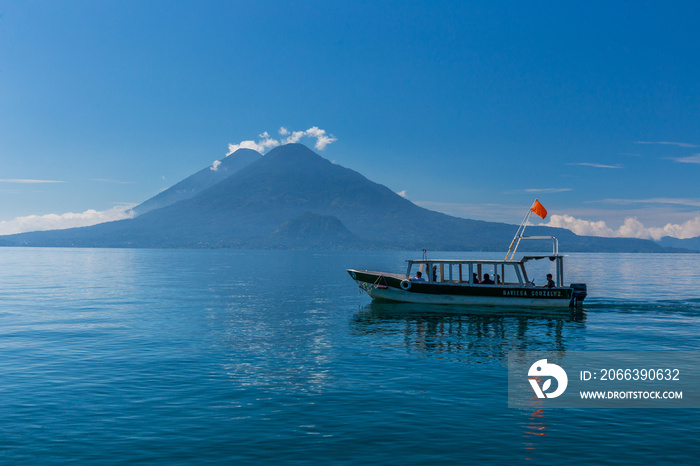 Lonely boat on the lake Atitlan in Guatemala with volcano in the background