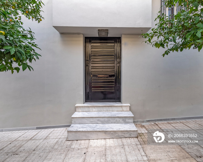 Contemporary house entrance black painted metal door, Athens Greece