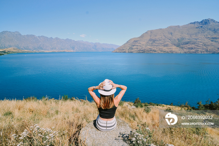 Woman on cliff in New Zealand.