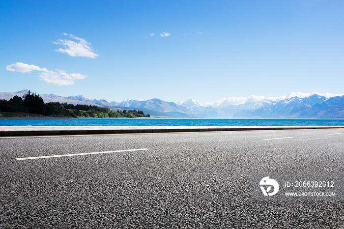 empty road with blue sea in blue sky