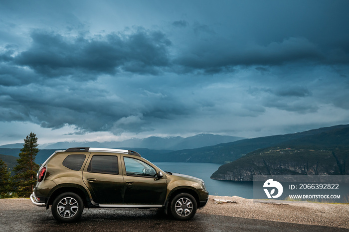 Utvik, Sogn Og Fjordane County, Norway. Car Suv Parked Near Scenic Route Road In Norwegian Mountain Lake Landscape. Innvikfjord Is A Sub-fjord Of Nordfjord.