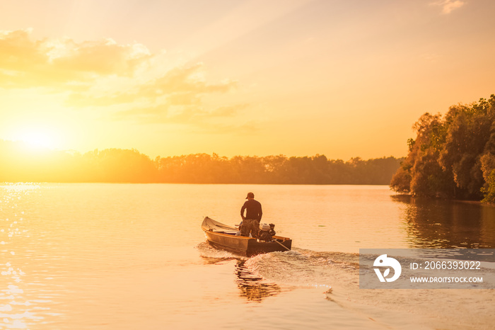 Speed fishing boat in the river with sunset,sunrise.