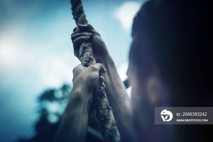 Man climbing a rope during obstacle course