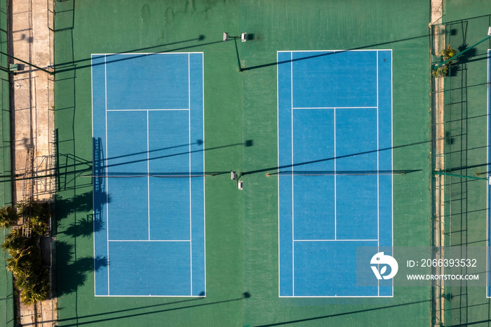 Aerial view of 2 tennis blue tennis courts. View from above.