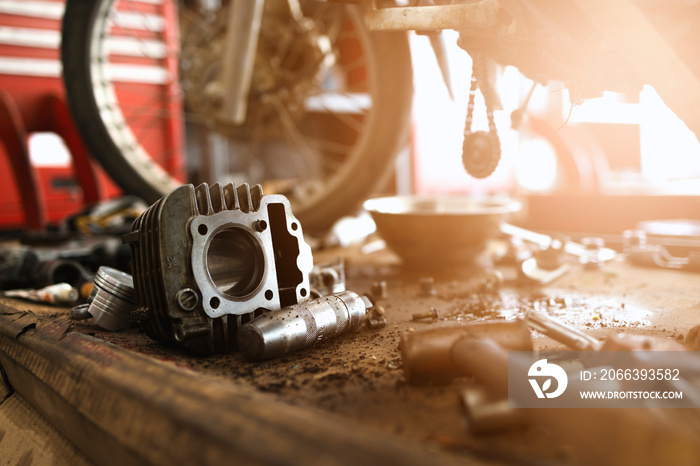 motorcycle engine repair with soft-focus and over light in the background