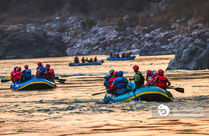 Young person rafting on the river Ganges in Rishikesh, extreme and fun sport at tourist attraction