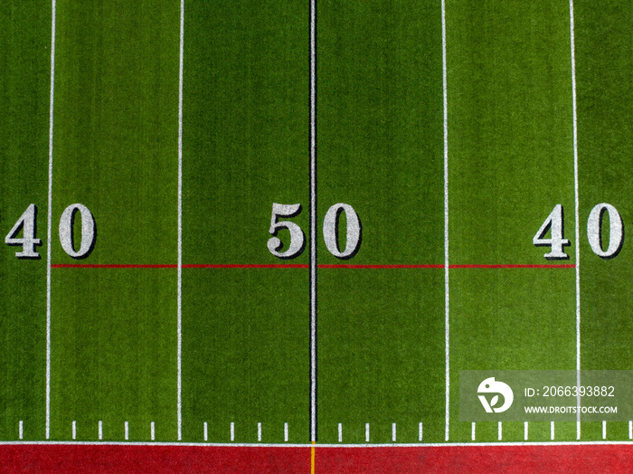 Aerial image of a typical synthetic turf football field 50 yard line in white.